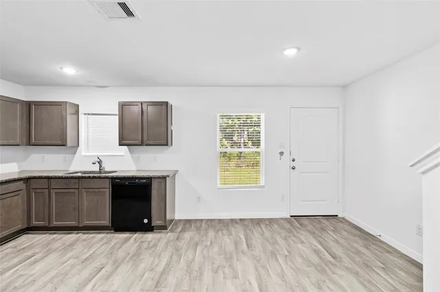 a large kitchen with stainless steel appliances granite countertop a stove and a sink