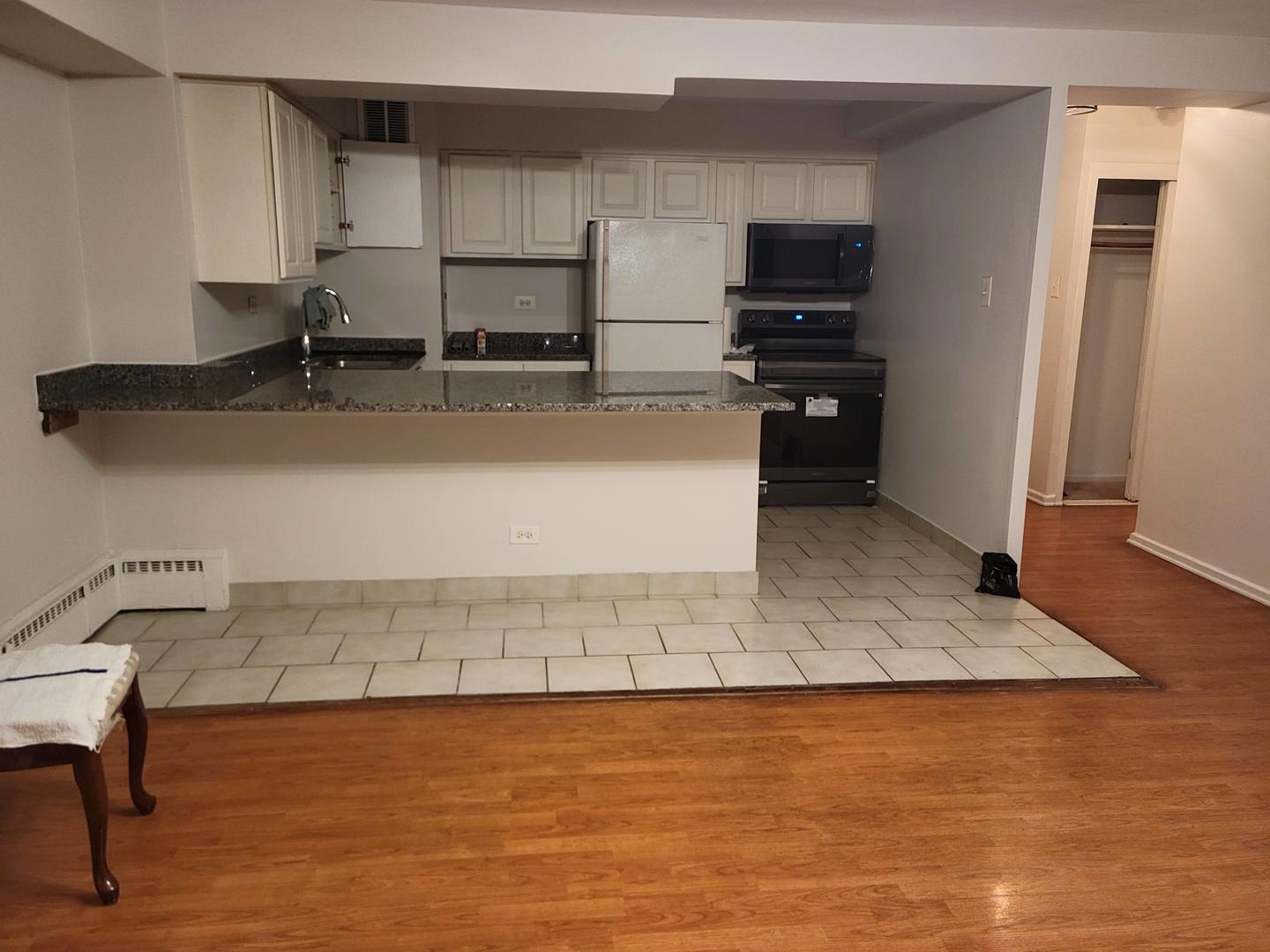 6030 North Sheridan Road, Unit 602 Chicago, IL 60660 - Photo 7 of 14 a kitchen with stainless steel appliances granite countertop a sink stove and a refrigerator