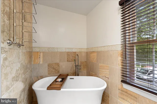 a view of backyard with table and chairs and wooden fence
