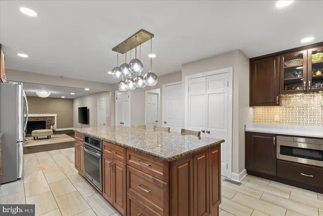 a bedroom with a large bed a flat screen tv and a couch