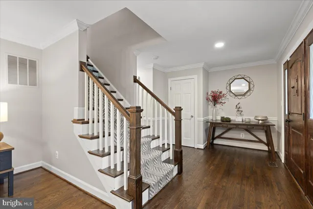 a view of entryway and hall with wooden floor