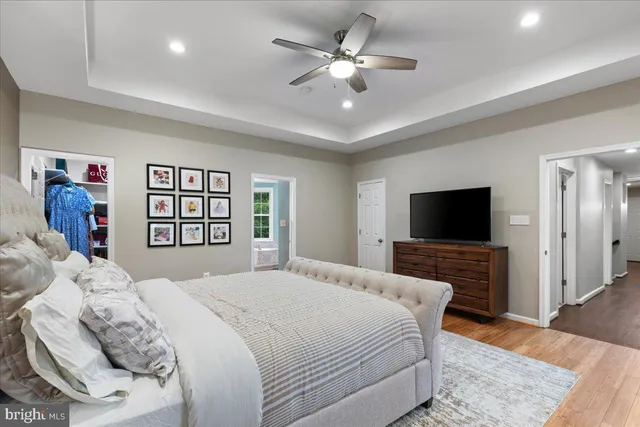 a bedroom with a large bed and a chandelier