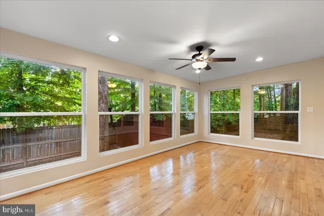 a bedroom with a bed couch and a large window