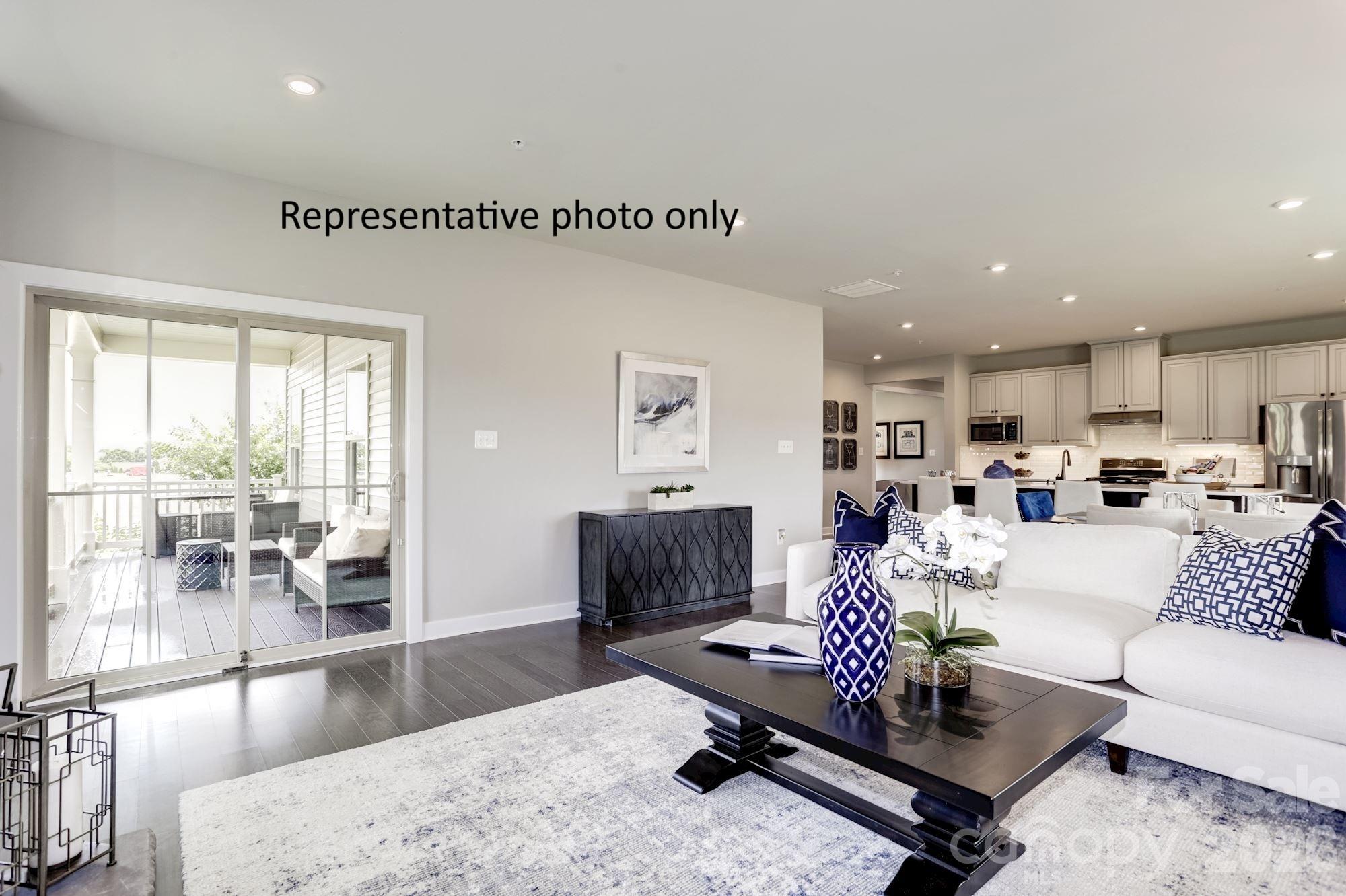 2023 Trout Brk Road, Unit 3230 Indian Trail, NC 28079 - Photo 3 of 10 a living room with furniture and a table with kitchen view