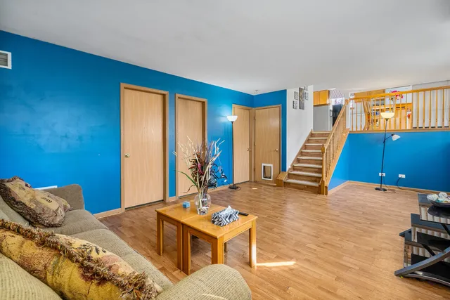 a living room with furniture a rug and a wooden floor