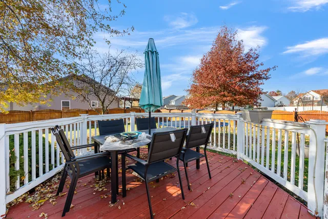 a view of deck with furniture and trees
