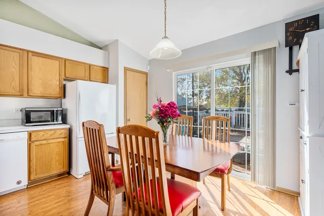 a dining room with furniture a chandelier and wooden floor