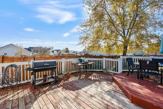 a view of a wooden deck with chairs