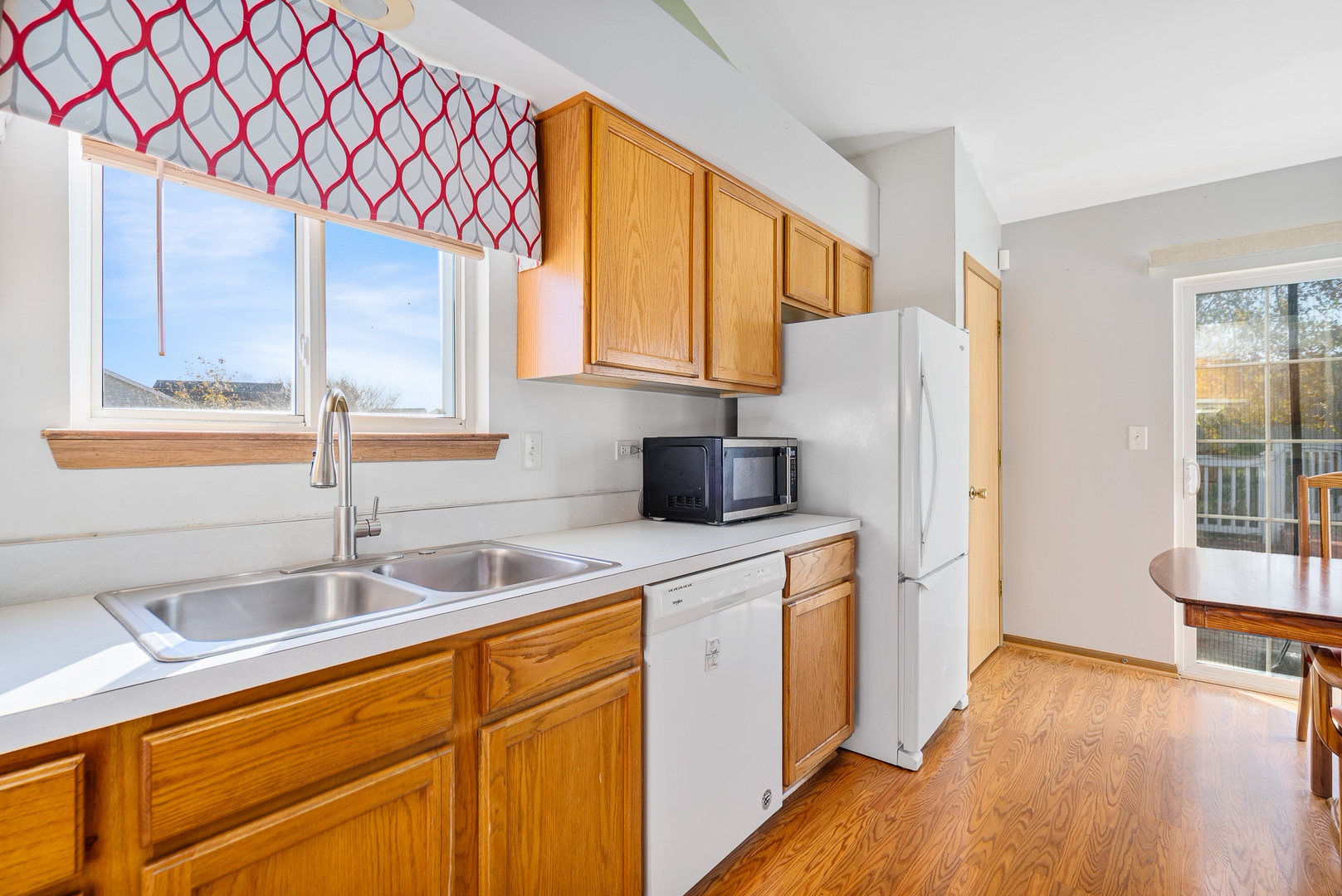 5221 West Mulberry Lane Monee, IL 60449 - Photo 3 of 32 a kitchen with stainless steel appliances a sink cabinets and a wooden floor