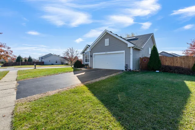 a view of a house with a swimming pool and a yard
