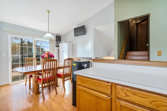 a dinning table with chairs and wooden floor