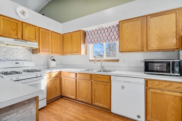 a kitchen with a sink stove and cabinets