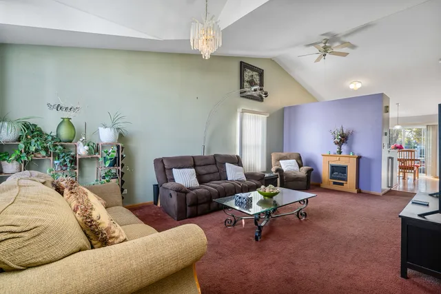 a living room with furniture and a chandelier
