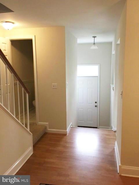 331 Davis Avenue Southwest Leesburg, VA 20175 - Photo 2 of 29 a view of an empty room with wooden floor and a window