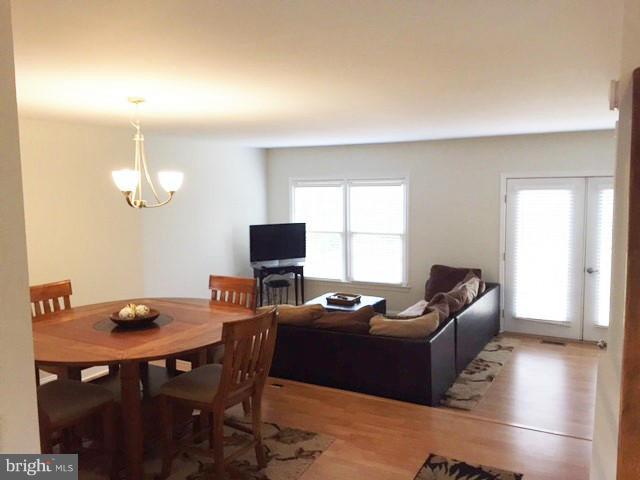 331 Davis Avenue Southwest Leesburg, VA 20175 - Photo 12 of 29 a living room with furniture a window and a flat screen tv
