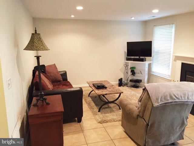 331 Davis Avenue Southwest Leesburg, VA 20175 - Photo 24 of 29 a living room with furniture and a flat screen tv