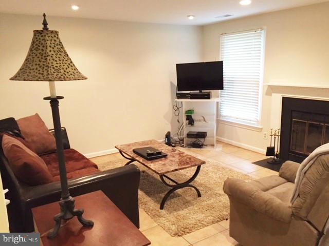 331 Davis Avenue Southwest Leesburg, VA 20175 - Photo 25 of 29 a living room with furniture and a flat screen tv