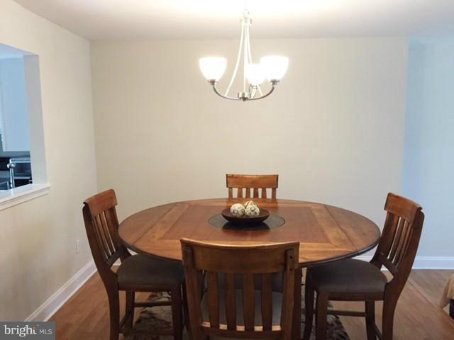 331 Davis Avenue Southwest Leesburg, VA 20175 - Photo 9 of 29 a dining room with furniture and chandelier