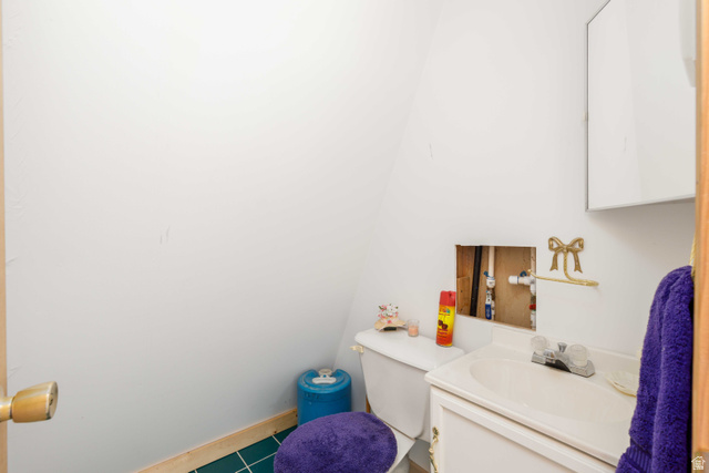 23 Scare Canyon, Unit 23 Logan, UT 84321 - Photo 13 of 33 Compact bathroom featuring a white toilet, white vanity with integrated sink, and a wall-mounted cabinet