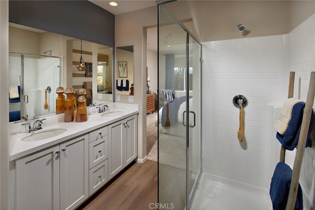 44376 Beringer Drive Indio, CA 92203 - Photo 10 of 17 a bathroom with a double vanity sink a shower and a mirror