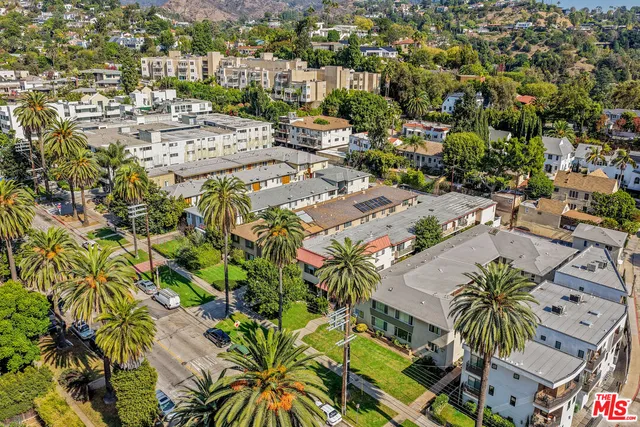an aerial view of residential houses with open space