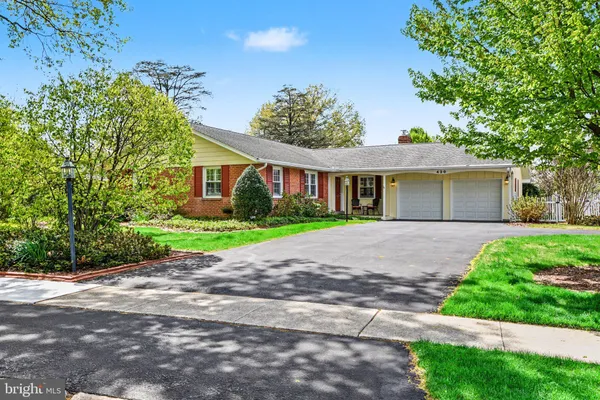 a house with green field in front of it