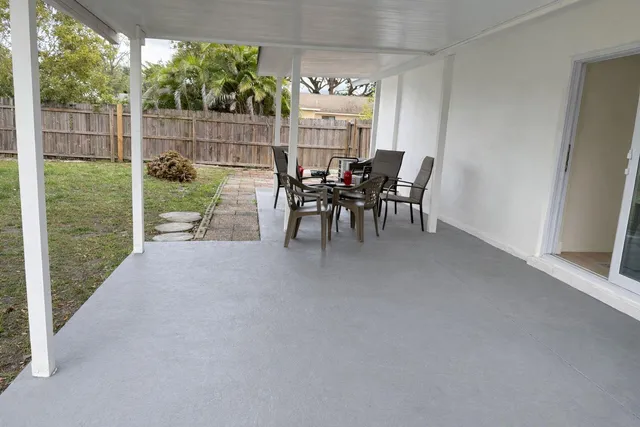 a view of a porch with chairs and backyard