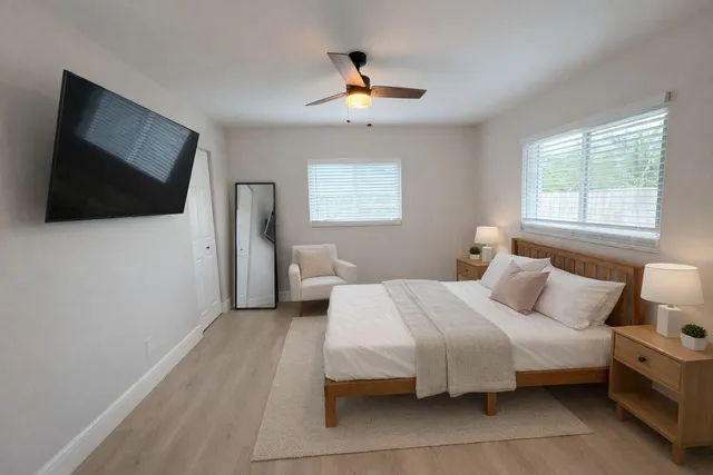 a bedroom with a bed and a flat screen tv