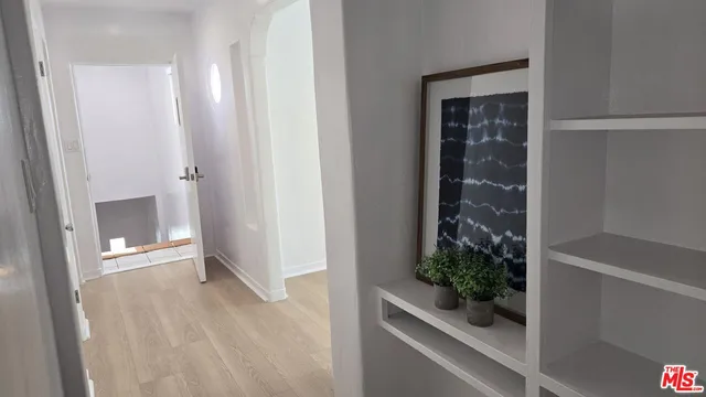 a view of a hallway with wooden floor