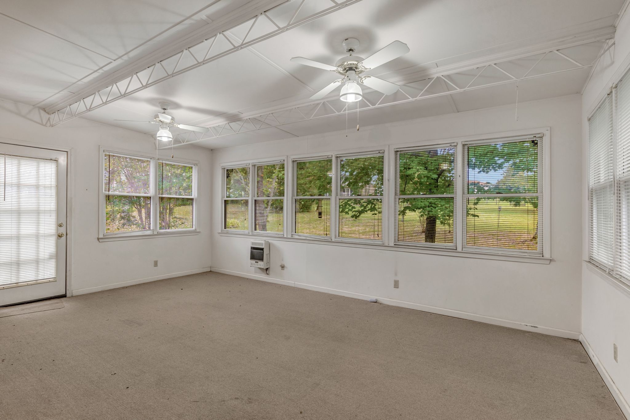 429 Nesbitt Lane Madison, TN 37115 - Photo 15 of 44 an empty room with windows and chandelier fan