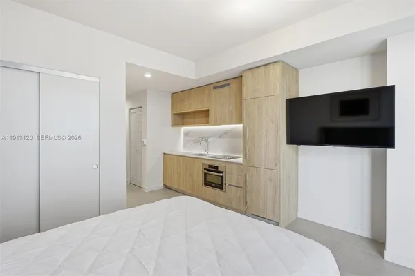 a bedroom with a bed and a flat screen tv