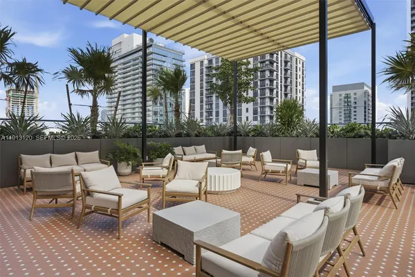 a view of swimming pool with outdoor seating and plants