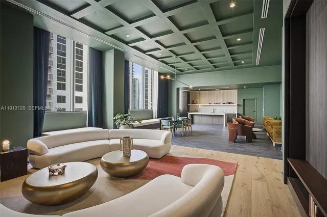 a living room with furniture a pool table and a large window