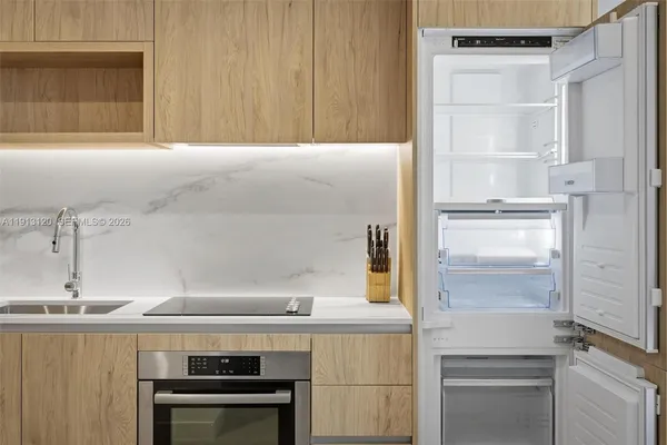 a kitchen with a sink and a refrigerator