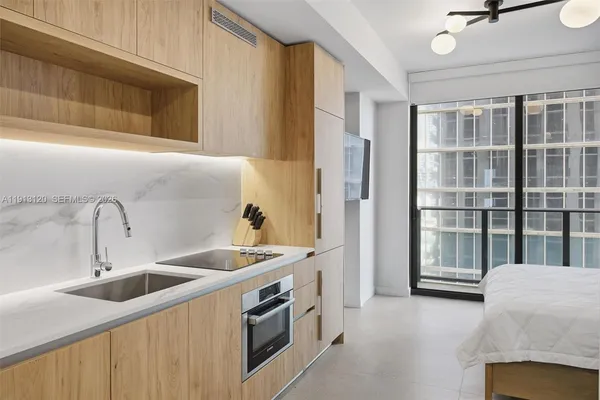 a kitchen with a sink and a refrigerator