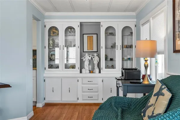 a living room with furniture and a dining table