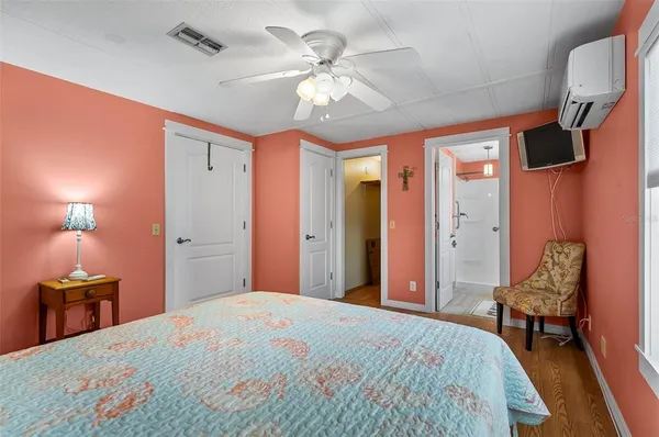 a bedroom with a bed and a chandelier