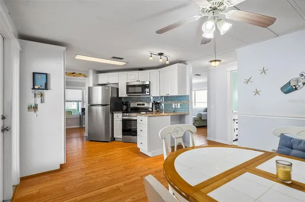 a kitchen with granite countertop a stove and a microwave