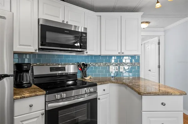 a kitchen with a refrigerator sink and stove