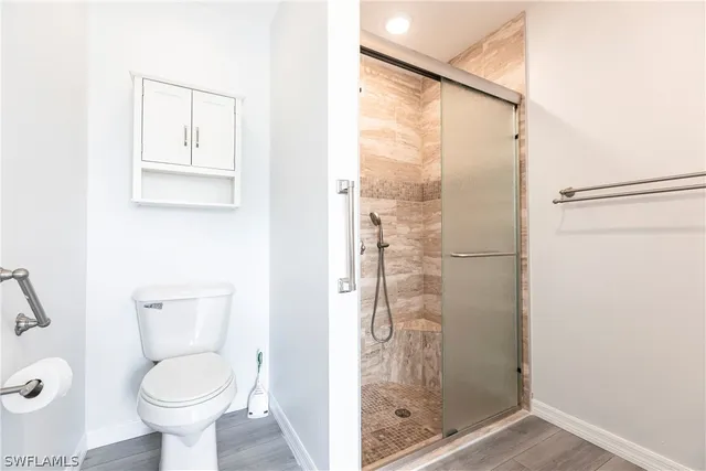 a bathroom with a toilet and a shower
