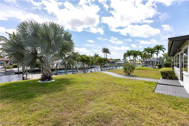 a view of yard with swimming pool and green space