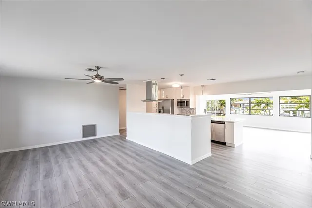 a view of a kitchen with wooden floor and a kitchen