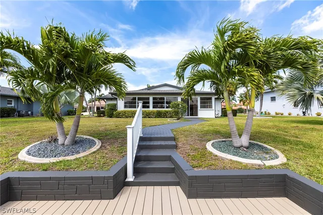 a swimming pool with barbeque oven outdoor seating yard and green space