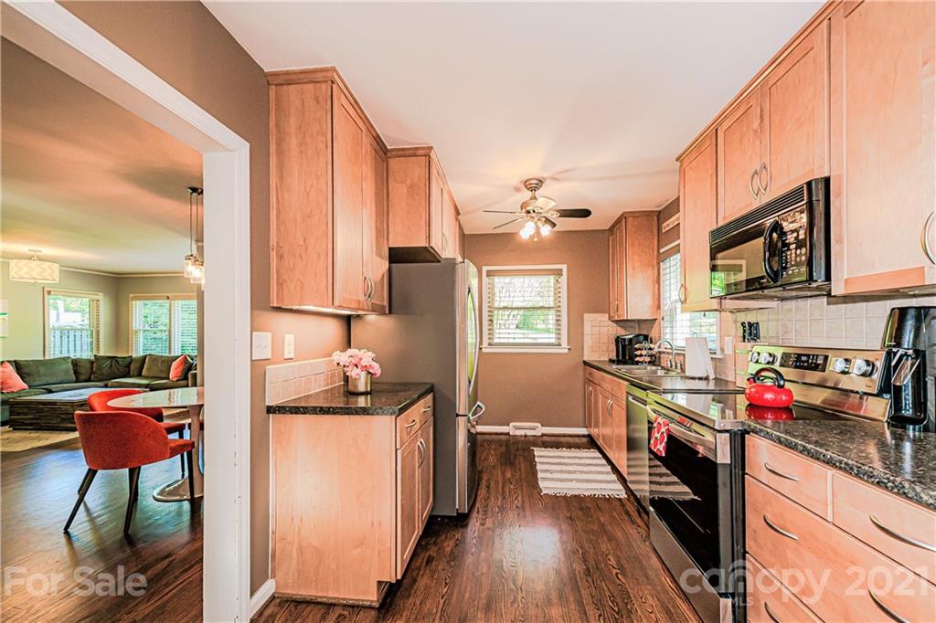 a kitchen with stainless steel appliances a stove a sink and a refrigerator