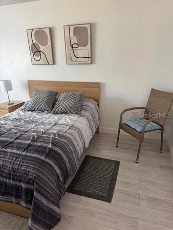 a bedroom with a bed and a chair