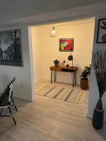 a view of a workspace with furniture and a potted plant