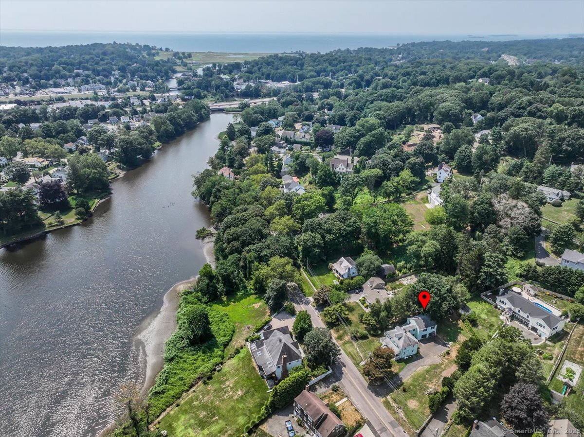 647 Bronson Road Fairfield, CT 06890 - Photo 5 of 10 an aerial view of a house with a yard and lake view
