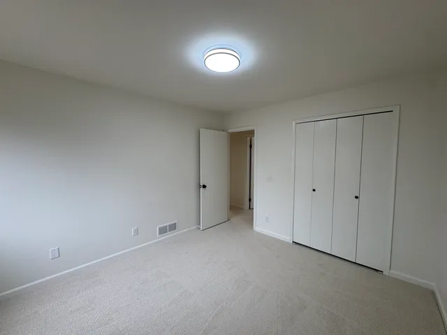 an empty room with closet area