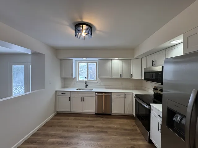a kitchen with a sink and cabinets
