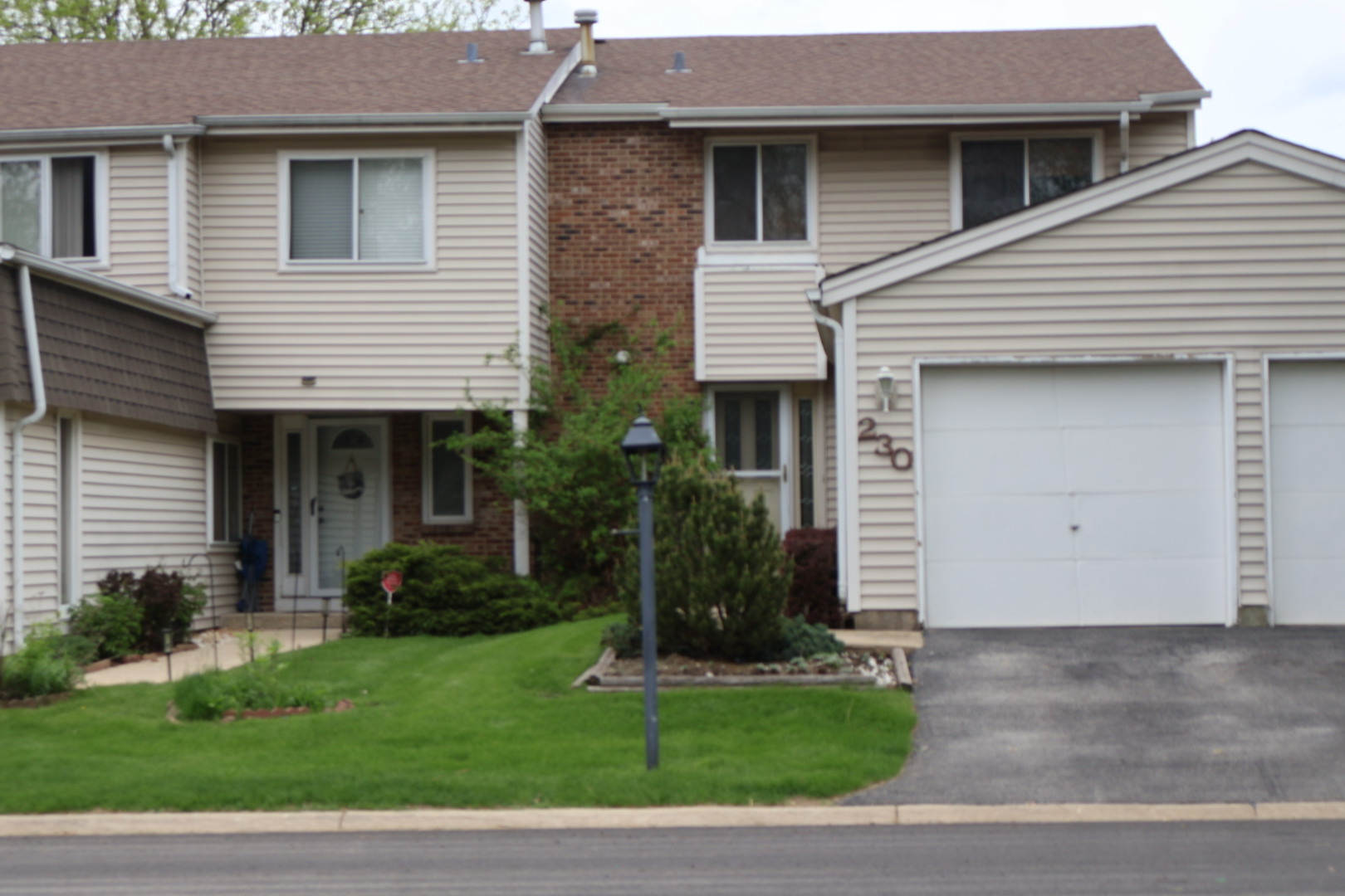 230 Douglass Way Bolingbrook, IL 60440 - Photo 1 of 16 a front view of a house with a garden